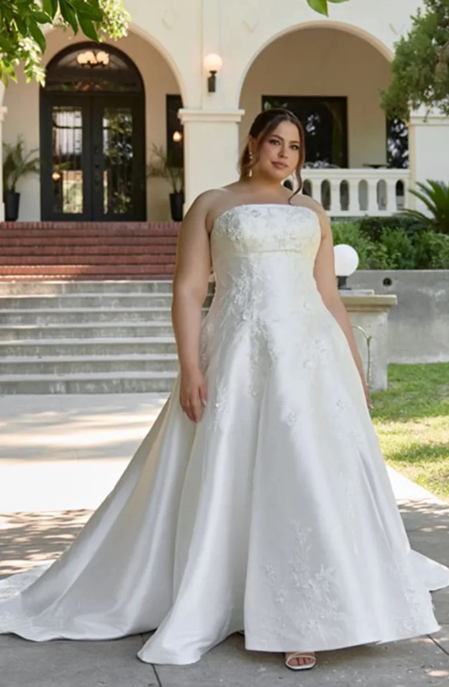 model is wearing a strapless a-line wedding dress