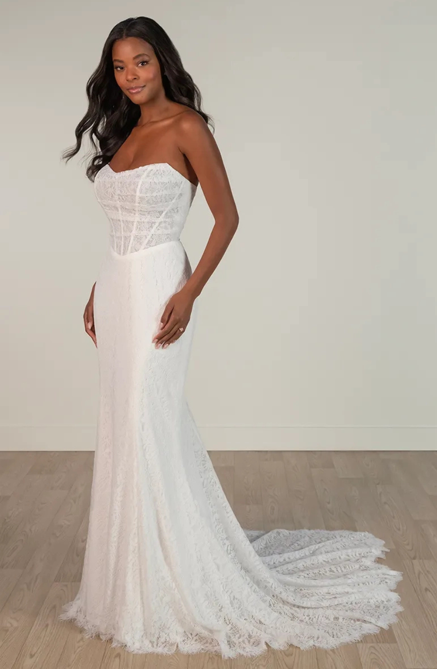 model is wearing a strapless fit and flare wedding dress