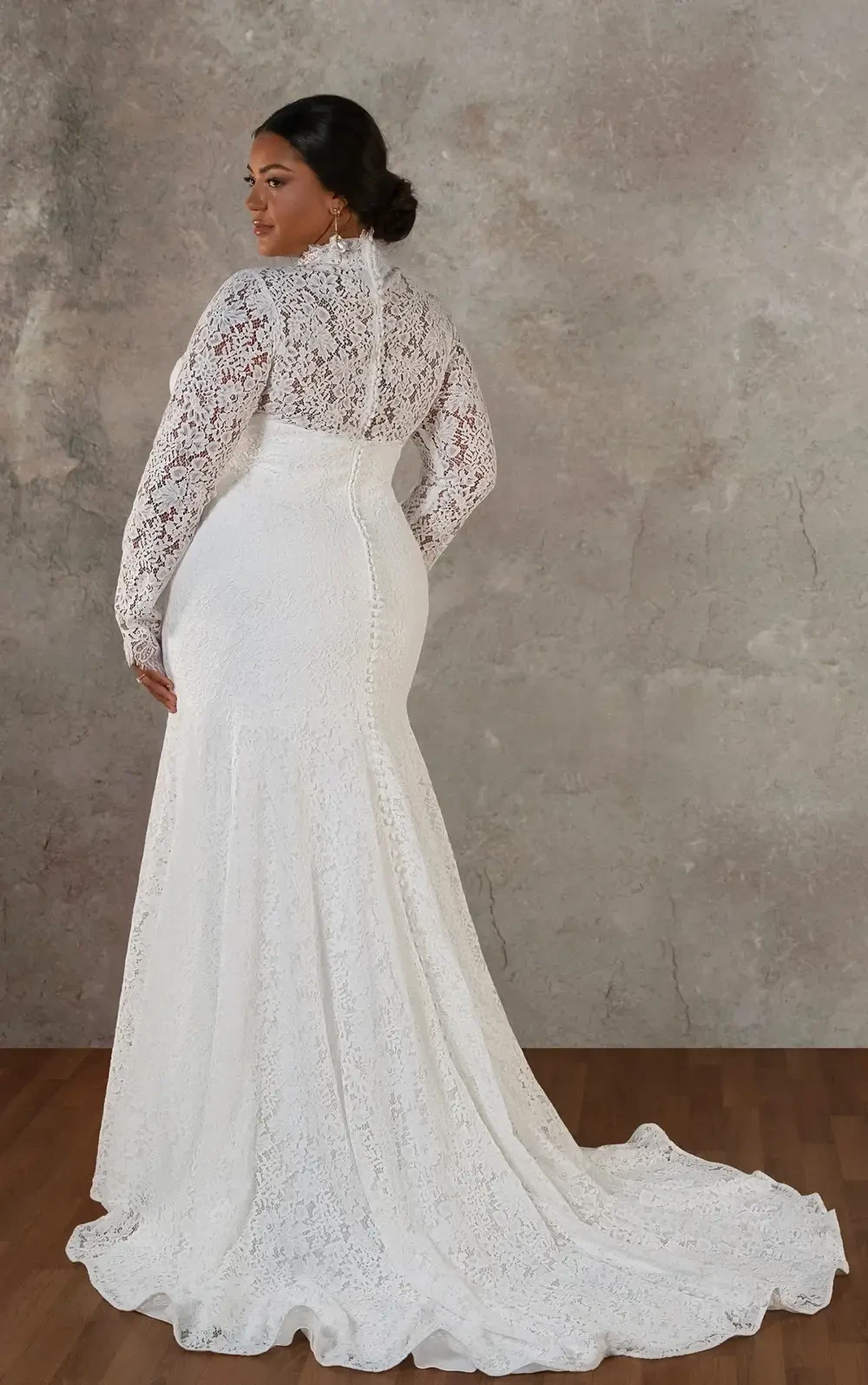 model is wearing a lace high neck long sleeve bridal gown