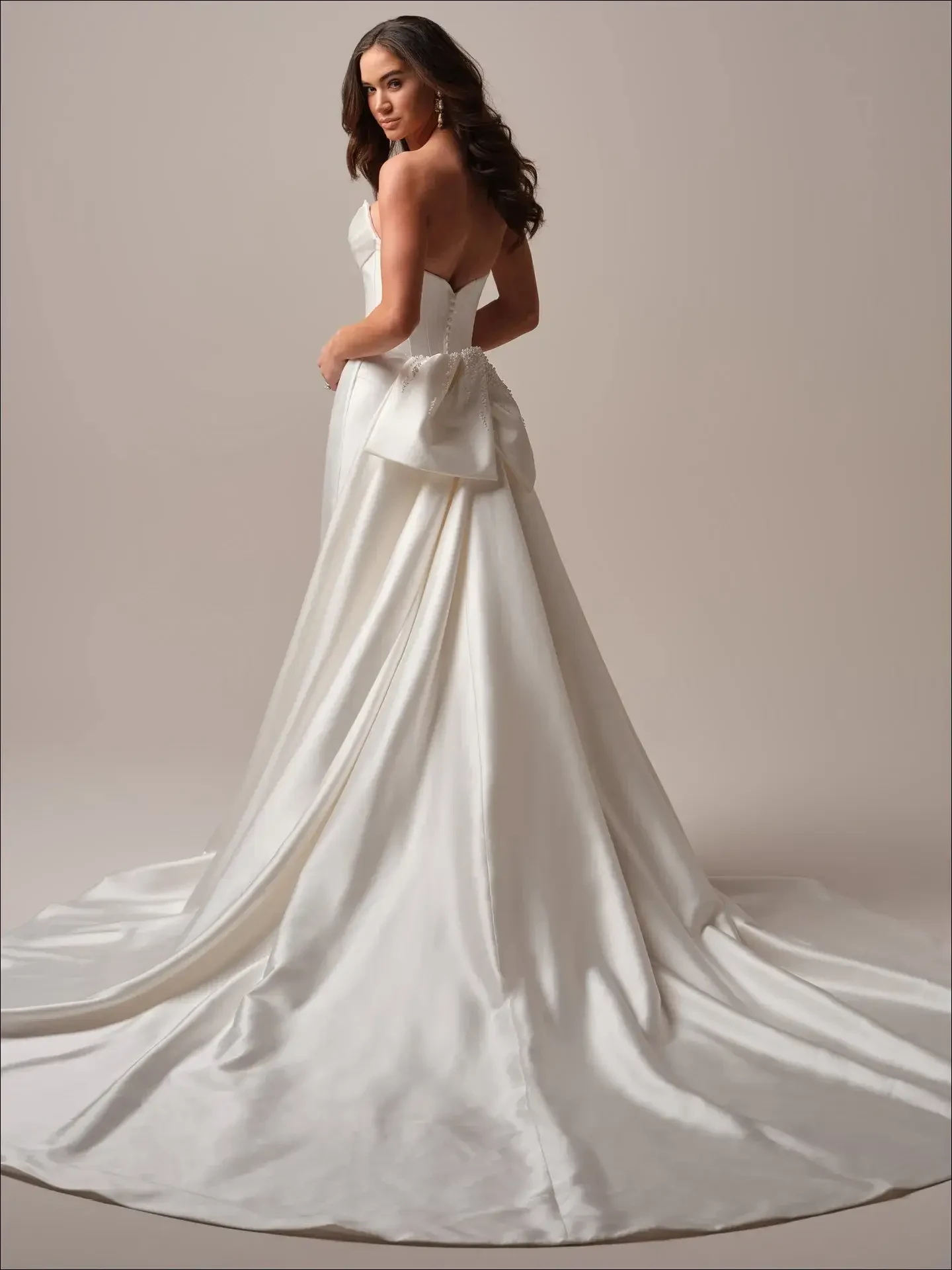 model is wearing a strapless bridal gown with optional detachable straps