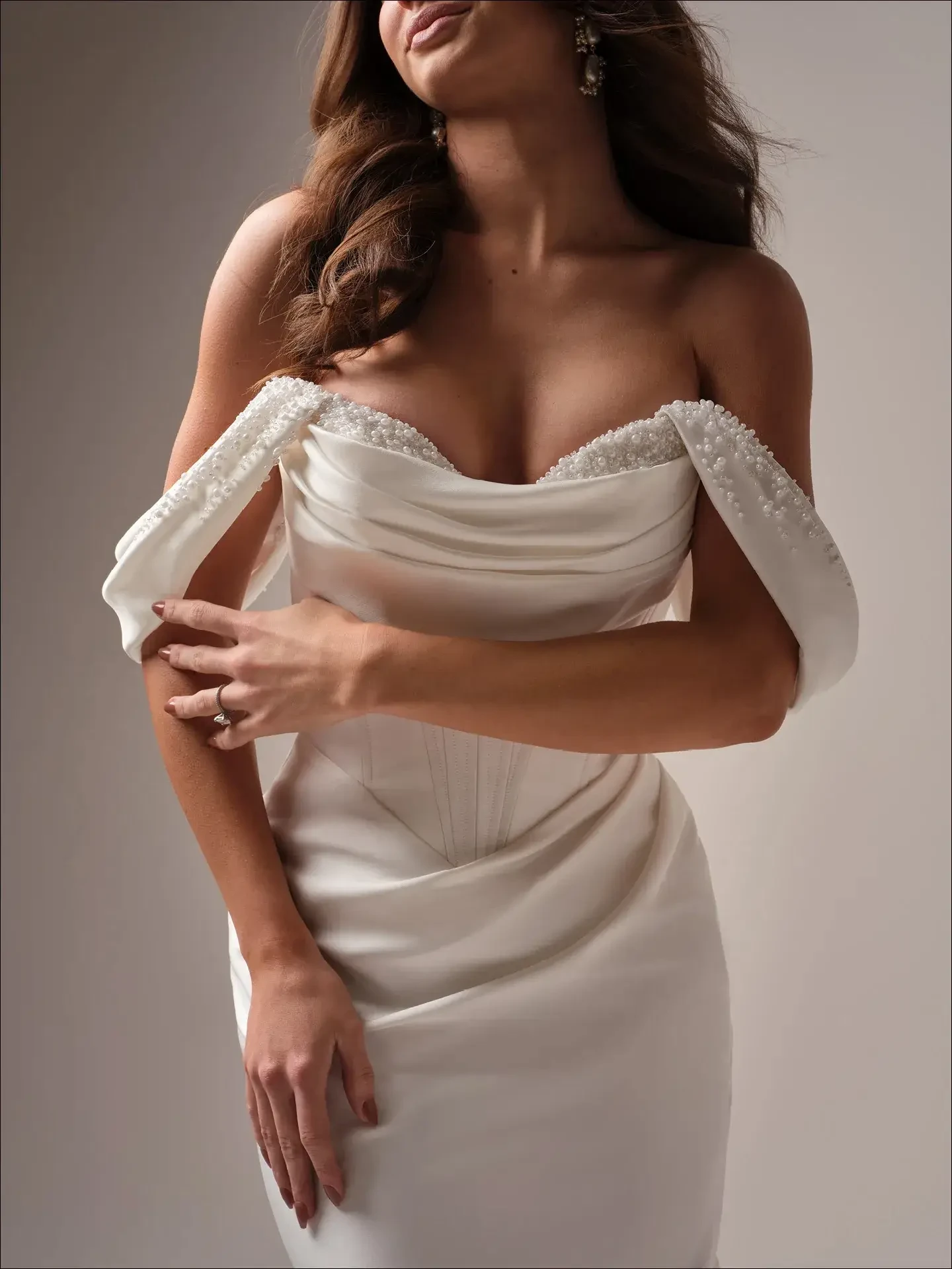 model is wearing a strapless bridal gown with optional detachable straps