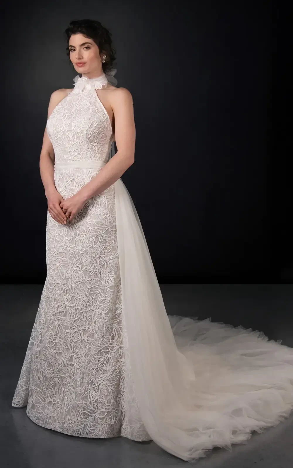 model is wearing a high neckline halter wedding gown