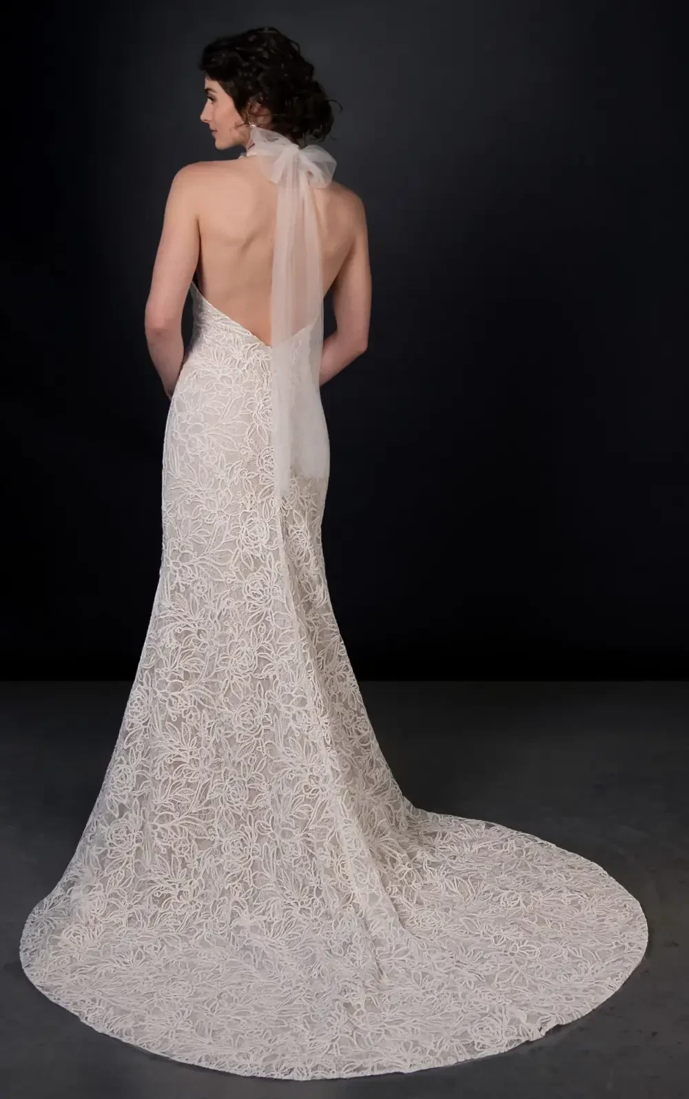 model is wearing a high neckline halter wedding gown