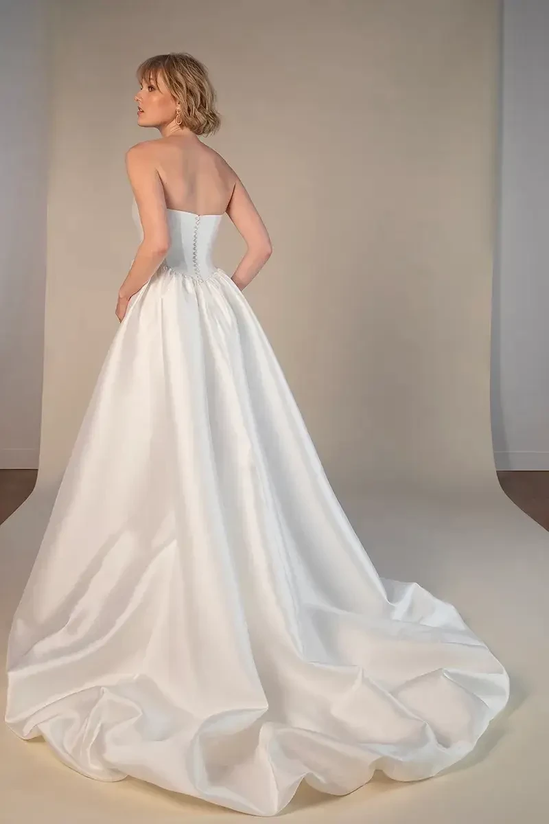 Model is wearing a strapless high low taffeta wedding dress