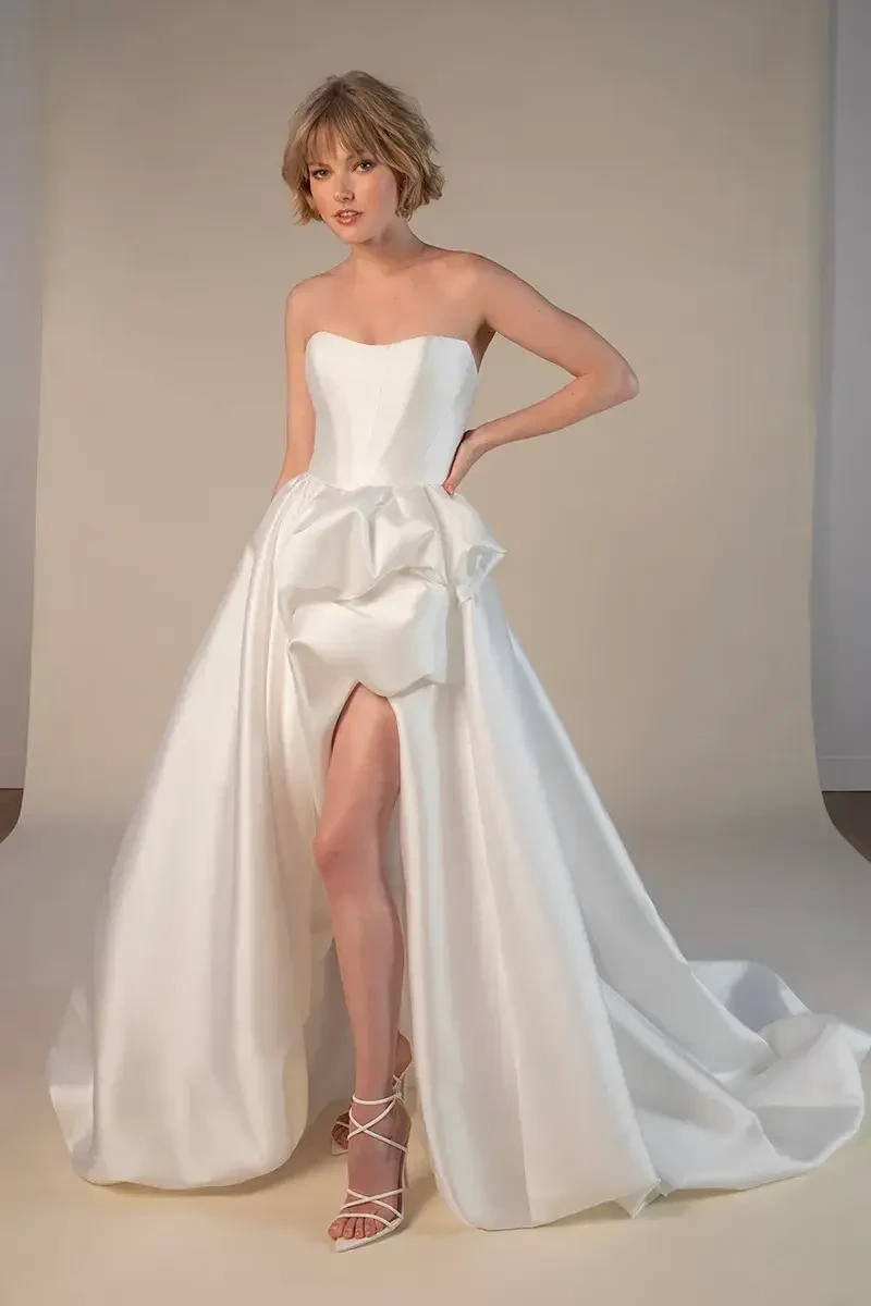 Model is wearing a strapless high low taffeta wedding dress